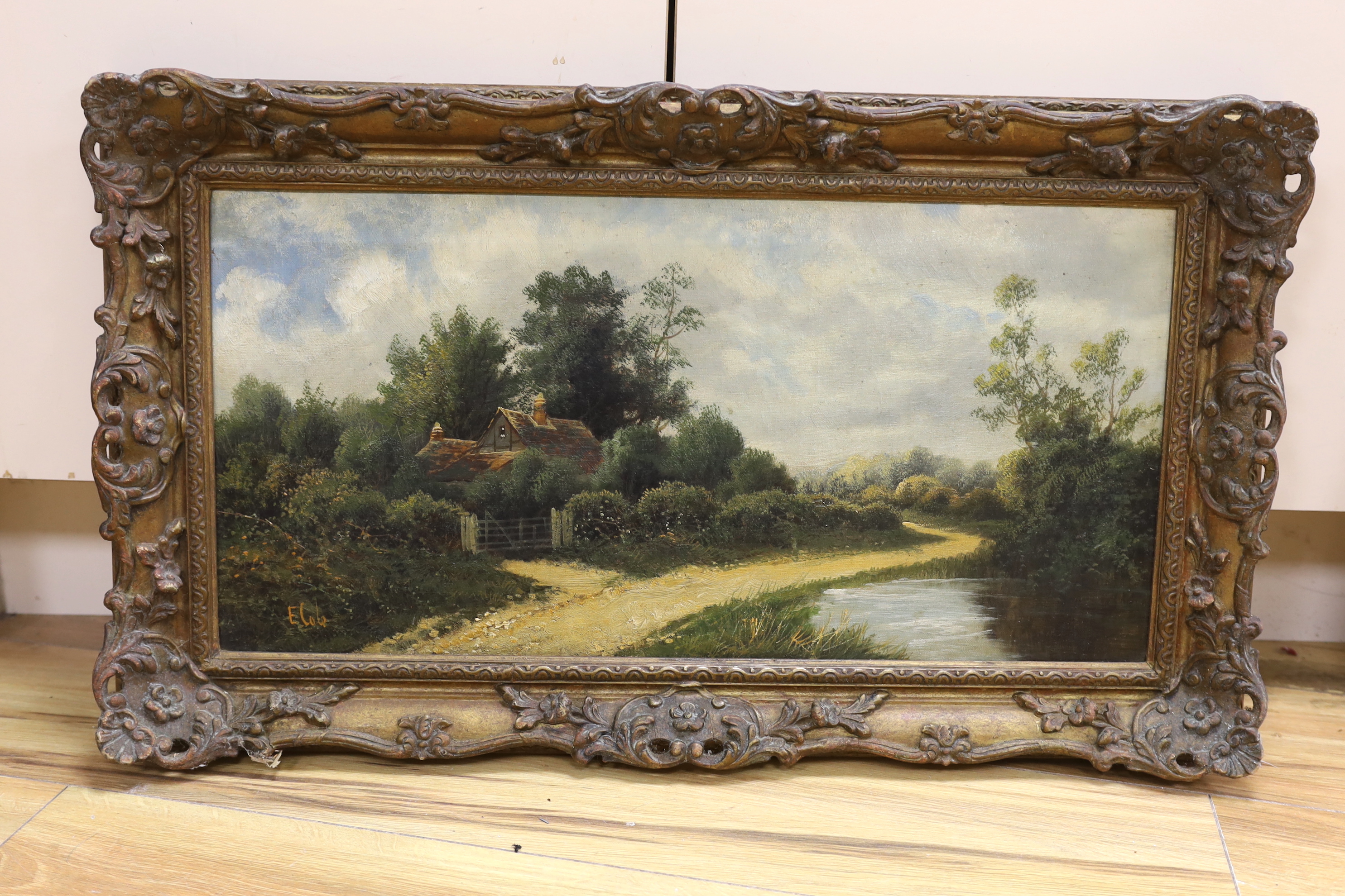 E. Cole, oil on canvas, Cottage in a landscape, signed, 29 x 60cm